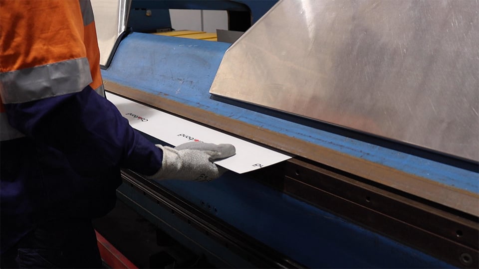 Roofing being rolled in machine